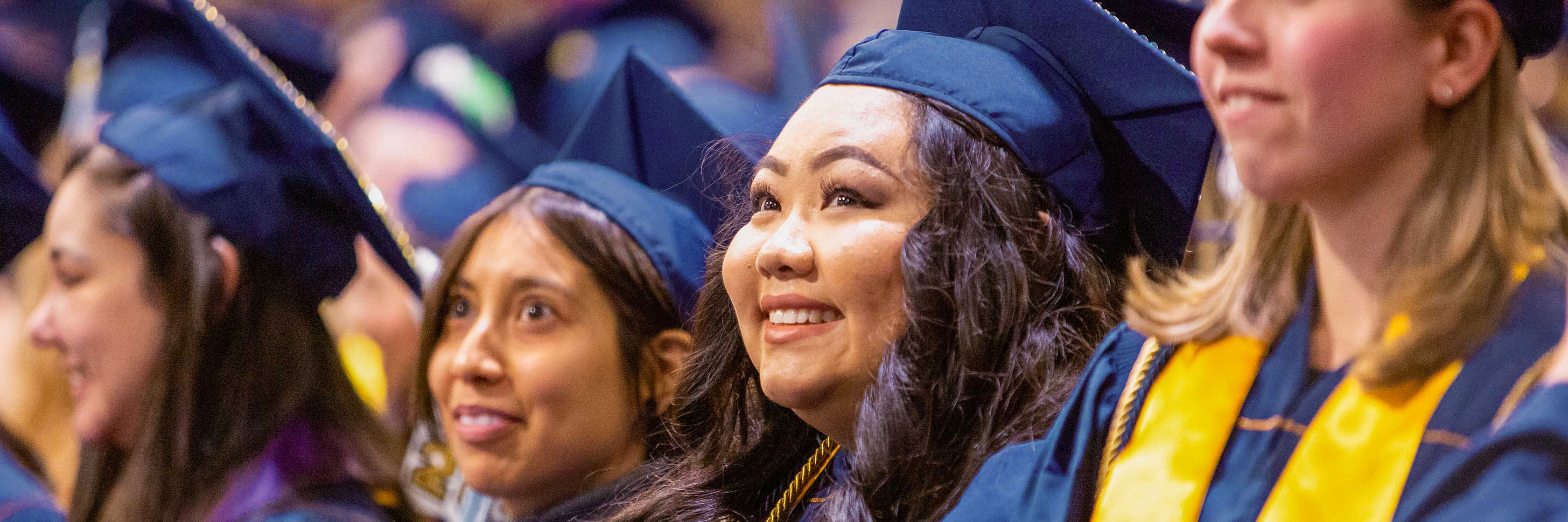 Graduate smiling during commencement.