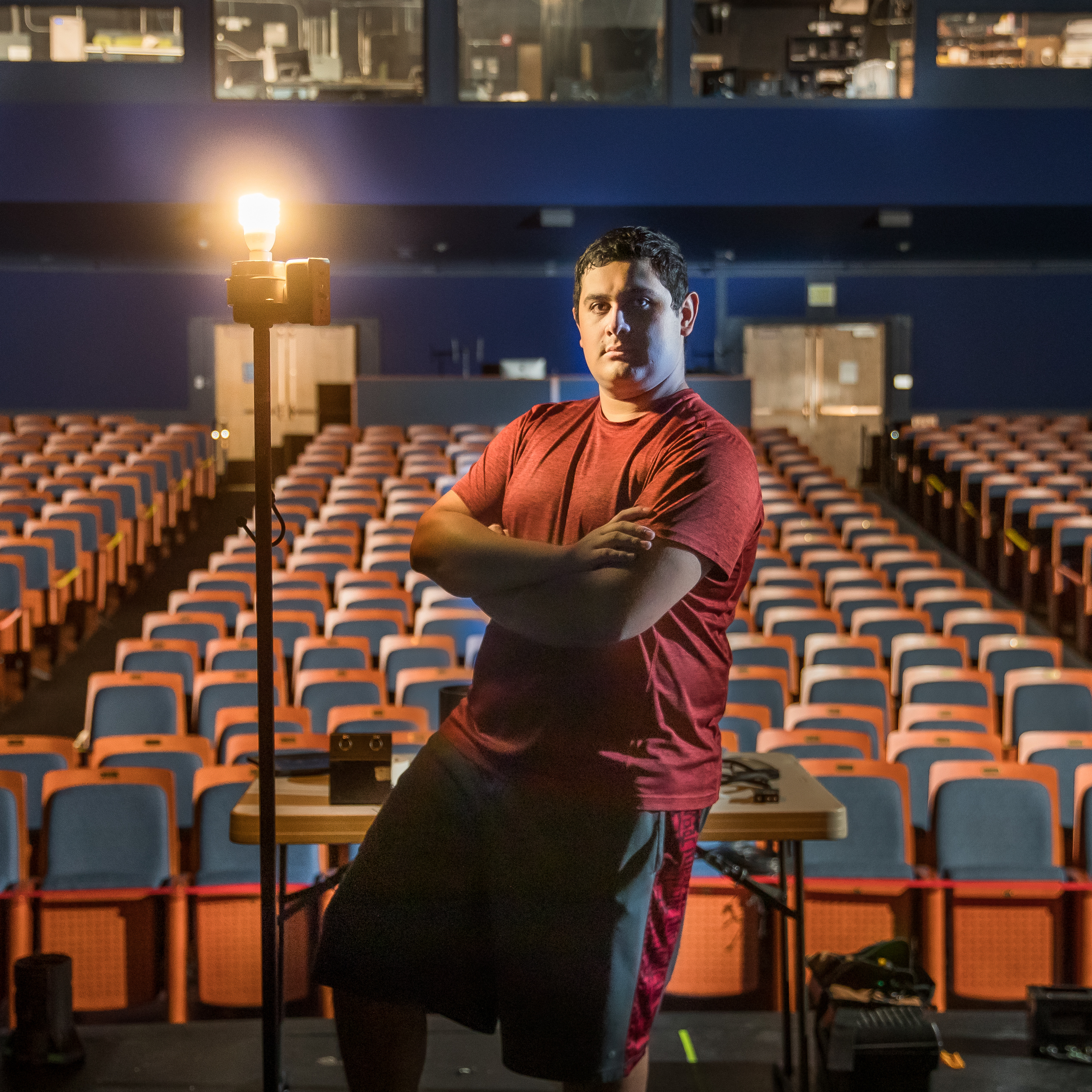 Theatre student Arteaga stands on stage before empty theater