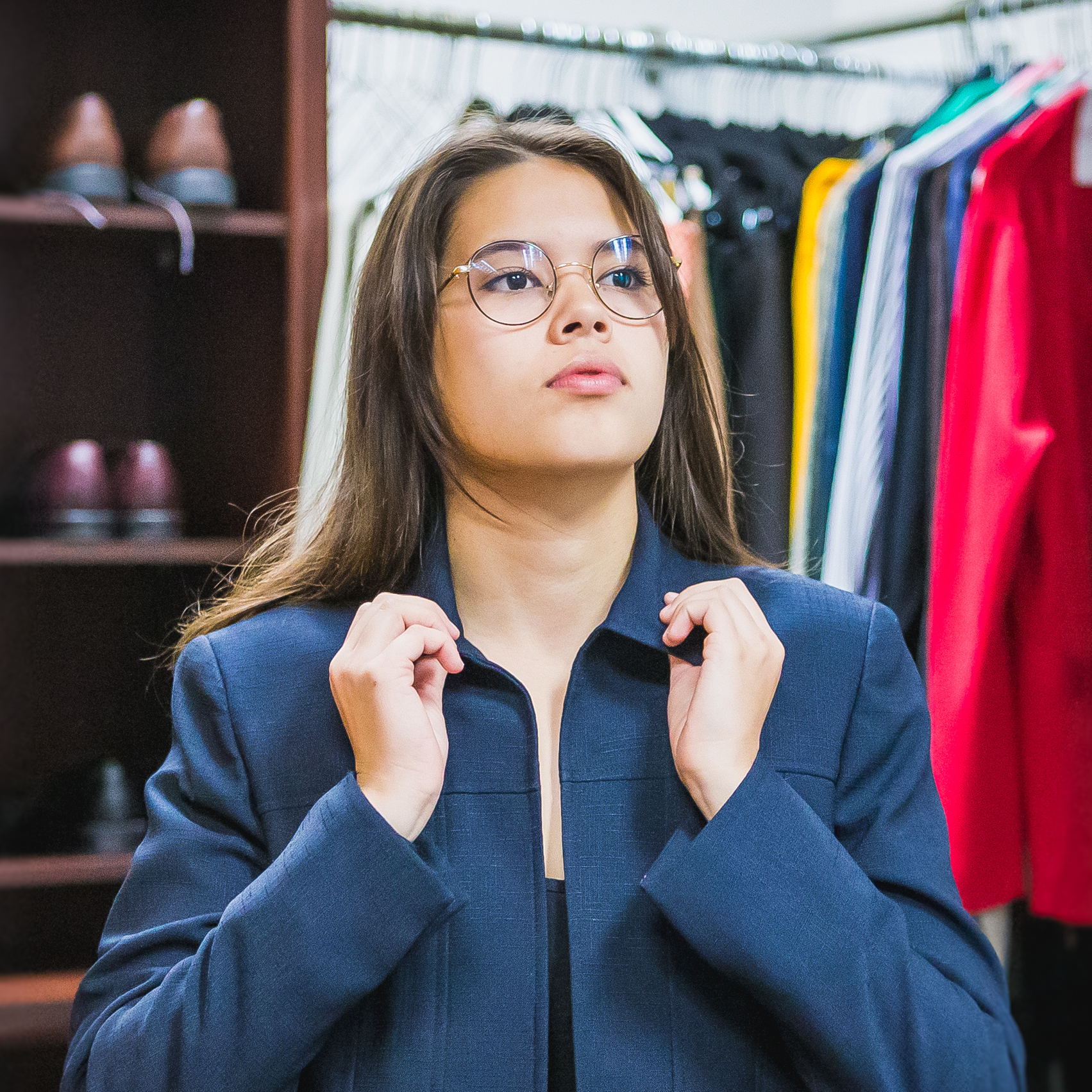 Student tries on blazer in UNC's Professional Attire Closet. 