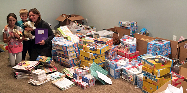 Murza with her kids and the bags she compiled together for the programs