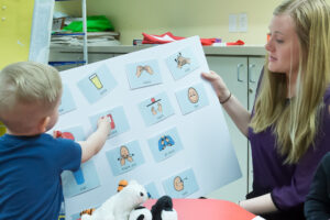 Graduate student assisting patient within the Communication Sciences Disorder Clinic.