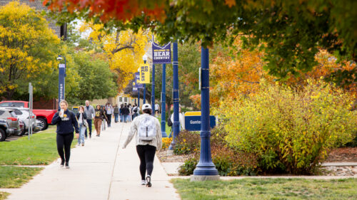 Students walking outside during fall weather