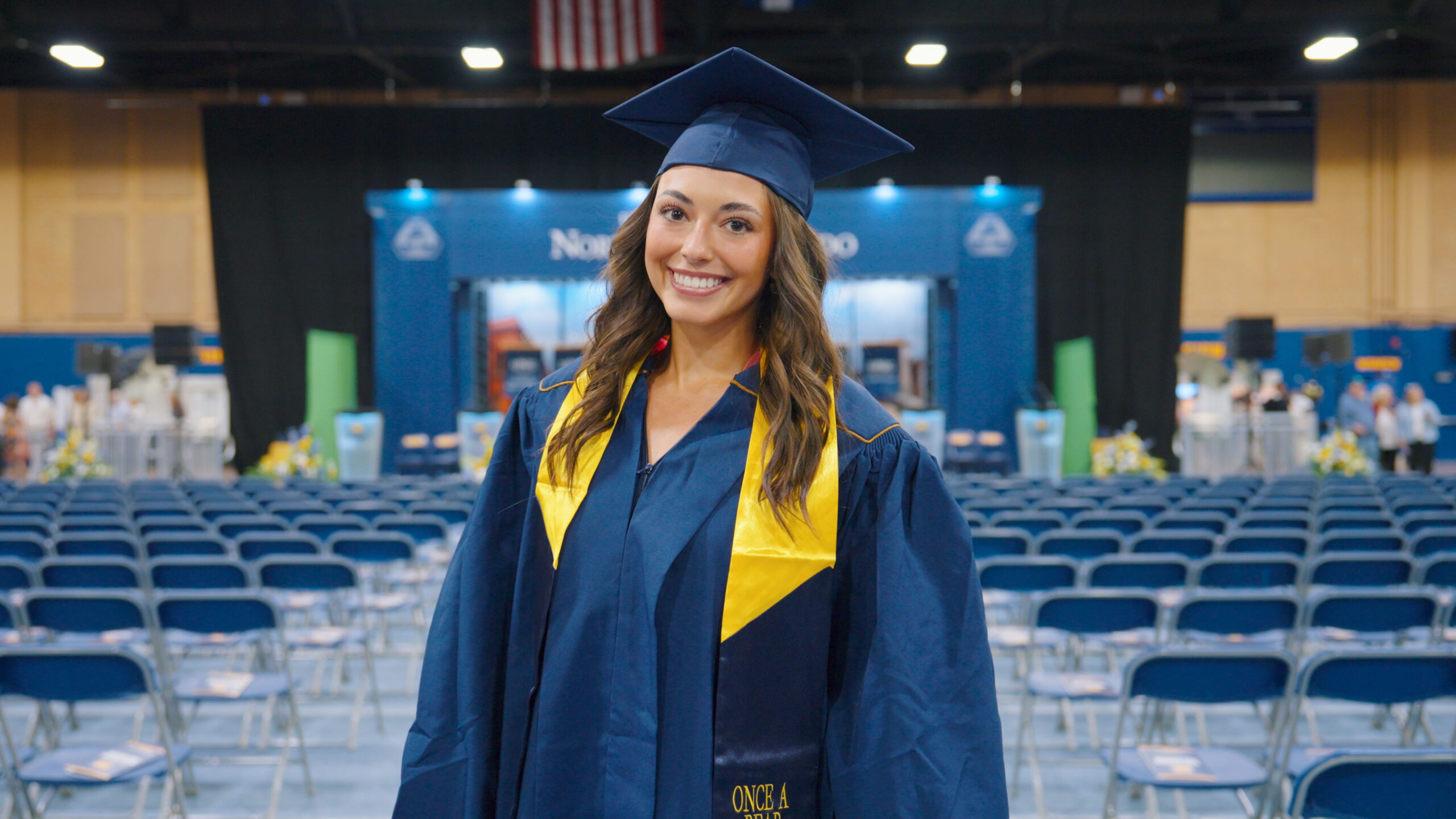 UNC Graduate poses in her cap and gown.