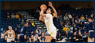 women's basketball player shooting a three pointer