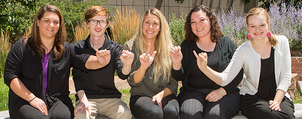 Five students fingerspelling ASLEI