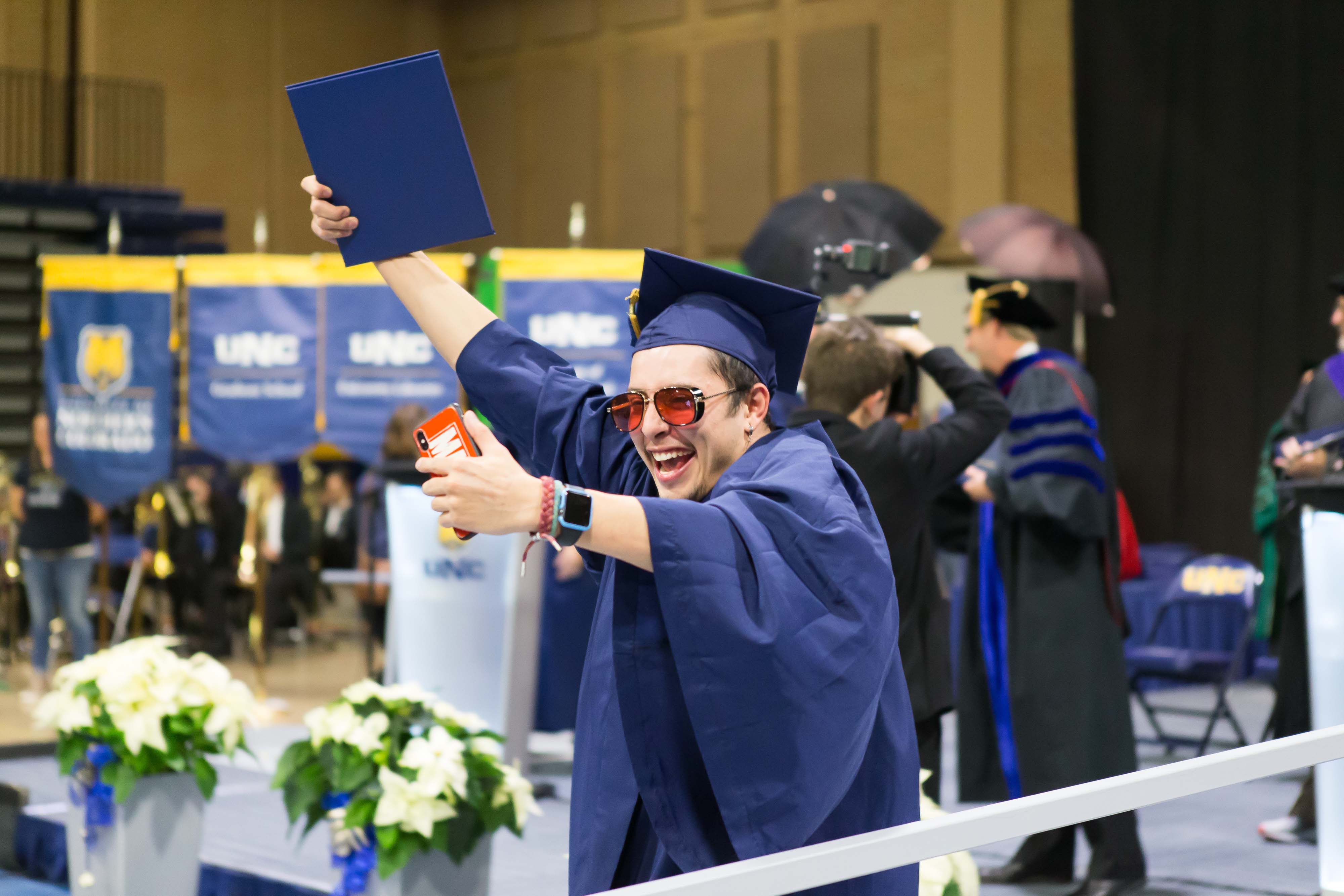 Student takes selfie with diploma