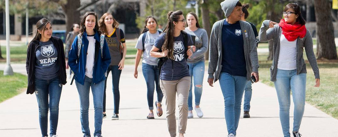 Students walking on the sidewalk.