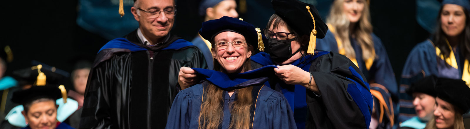 Student being hooded at doctoral commencement ceremony 