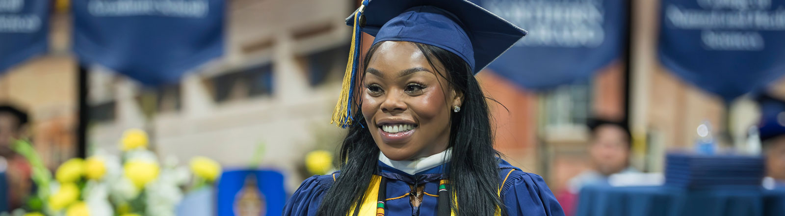 Graduating doctoral student looking out at audience at commencement cereomny