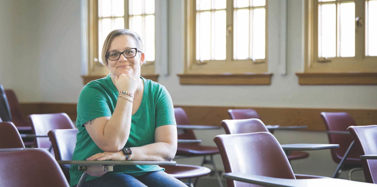 Jennifer Hayden smiles while seated at a desk.