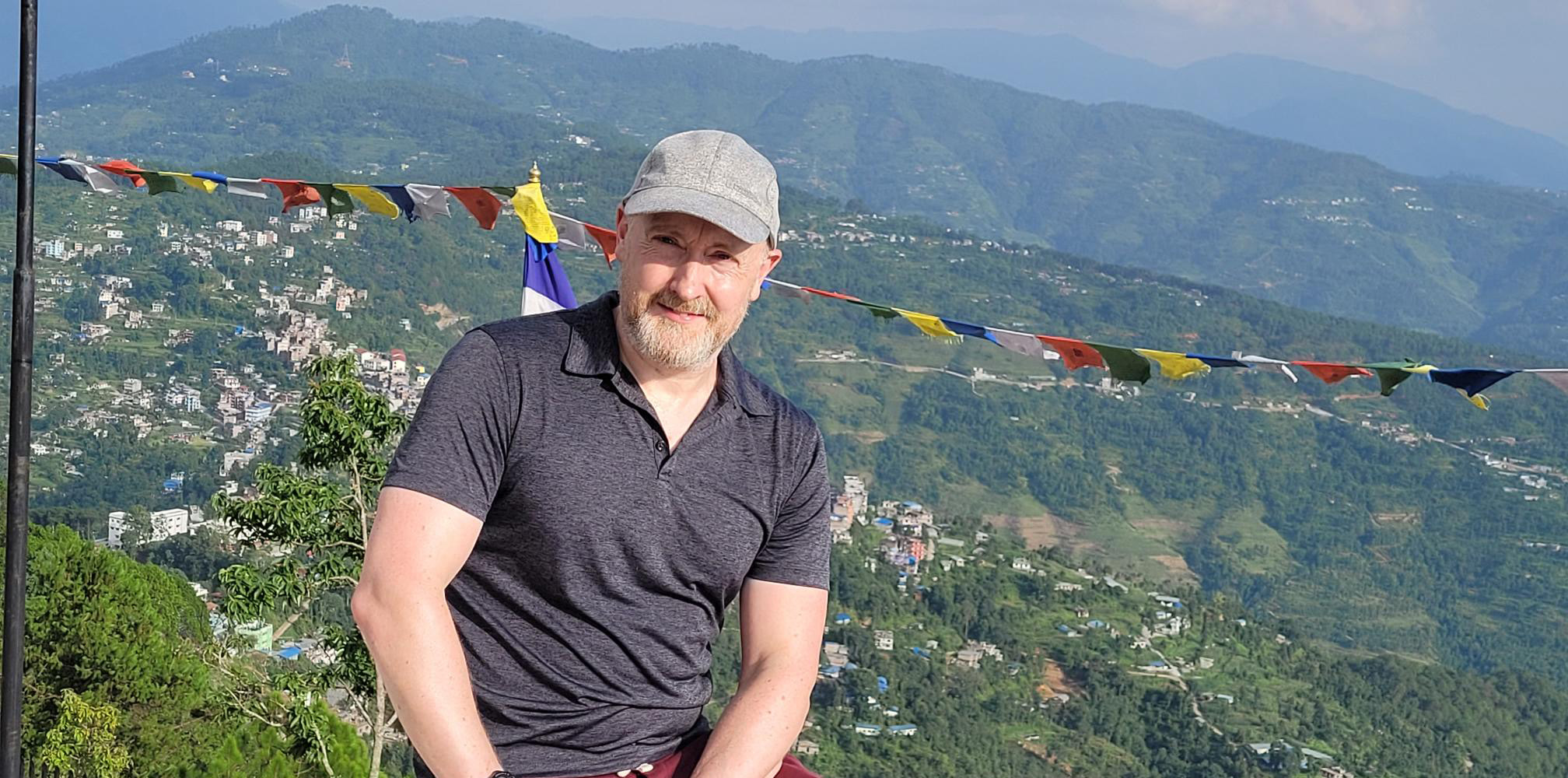 Richard Bownas posing with the Himalayan Mountains in the background