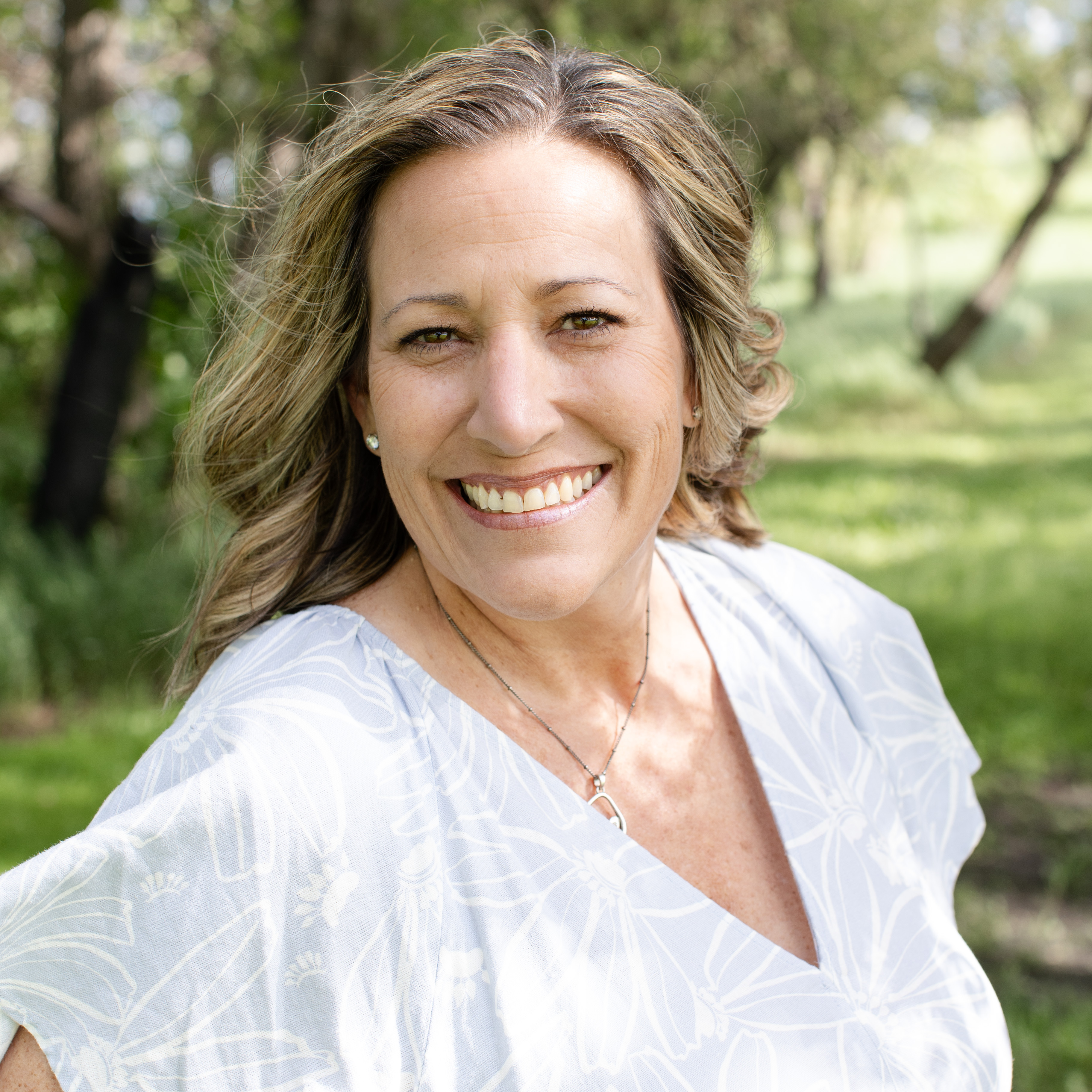 Brandy Smith-Love smiling outside wearing a white shirt