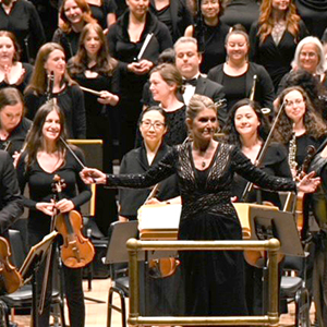 Jill Burgett conducting on stage at Carnegie Hall