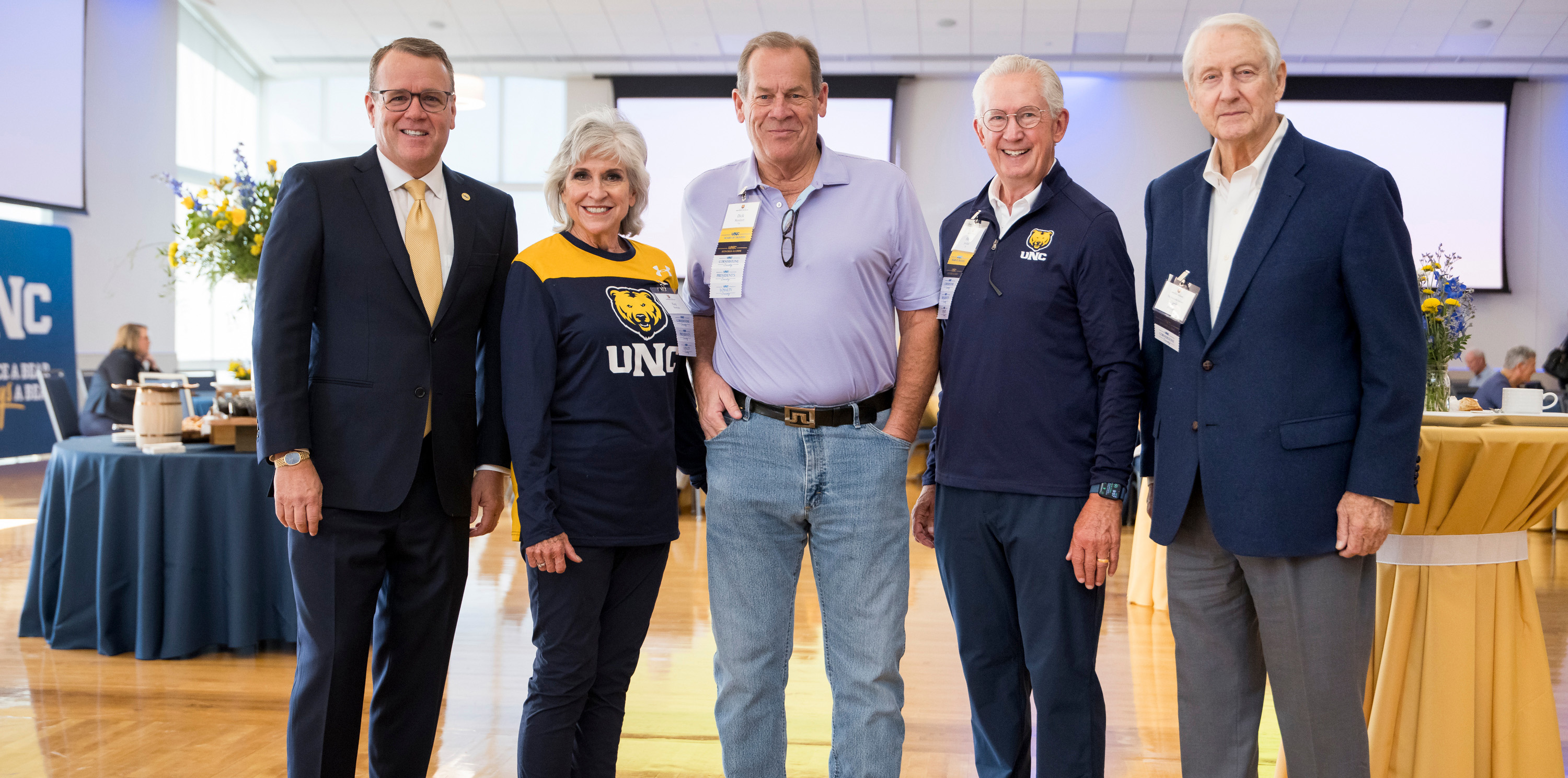 Four adults smiling at the camera