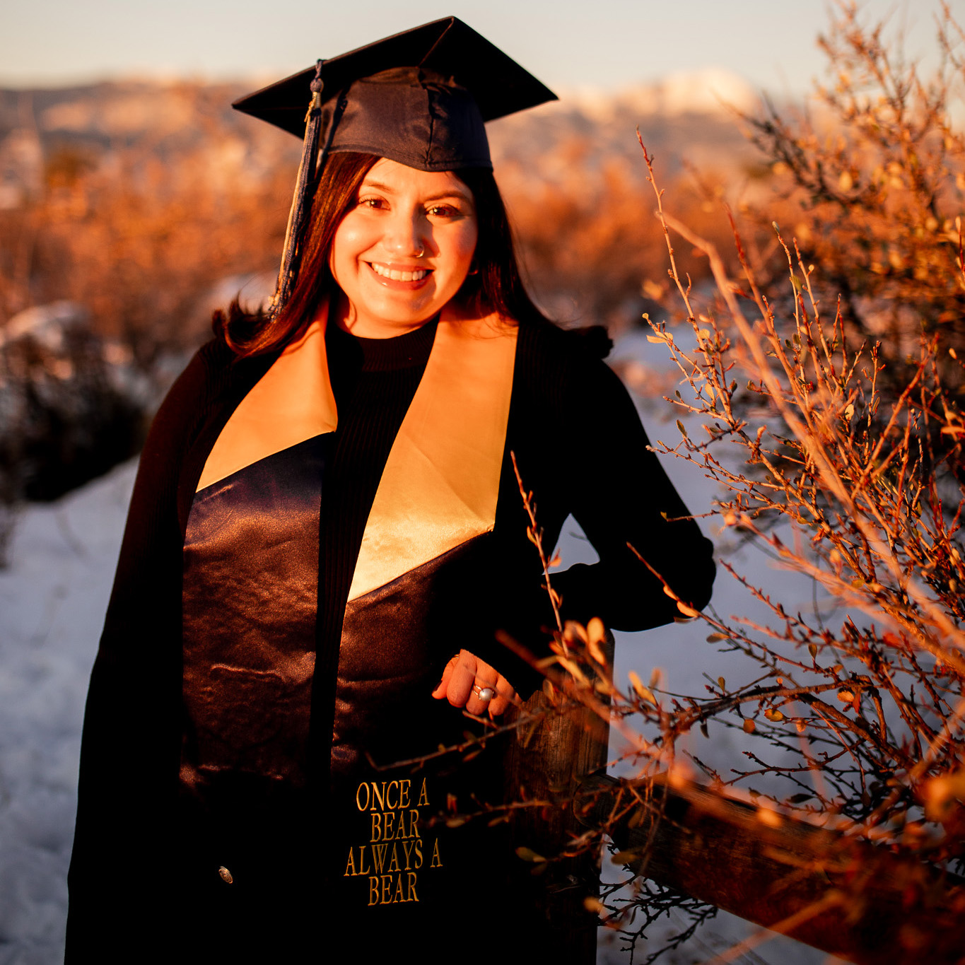 Dana Velazquez smiling in her cap and gown outside