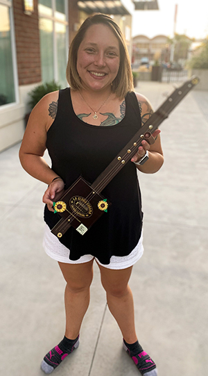 Jackelyn Hamlin holding self-made guitar from previous class