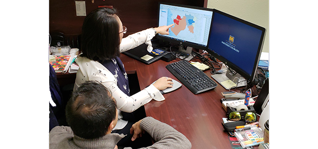 Drs. Lee and Ramirez reviewing a map of disease risk in Peru during El Nino.