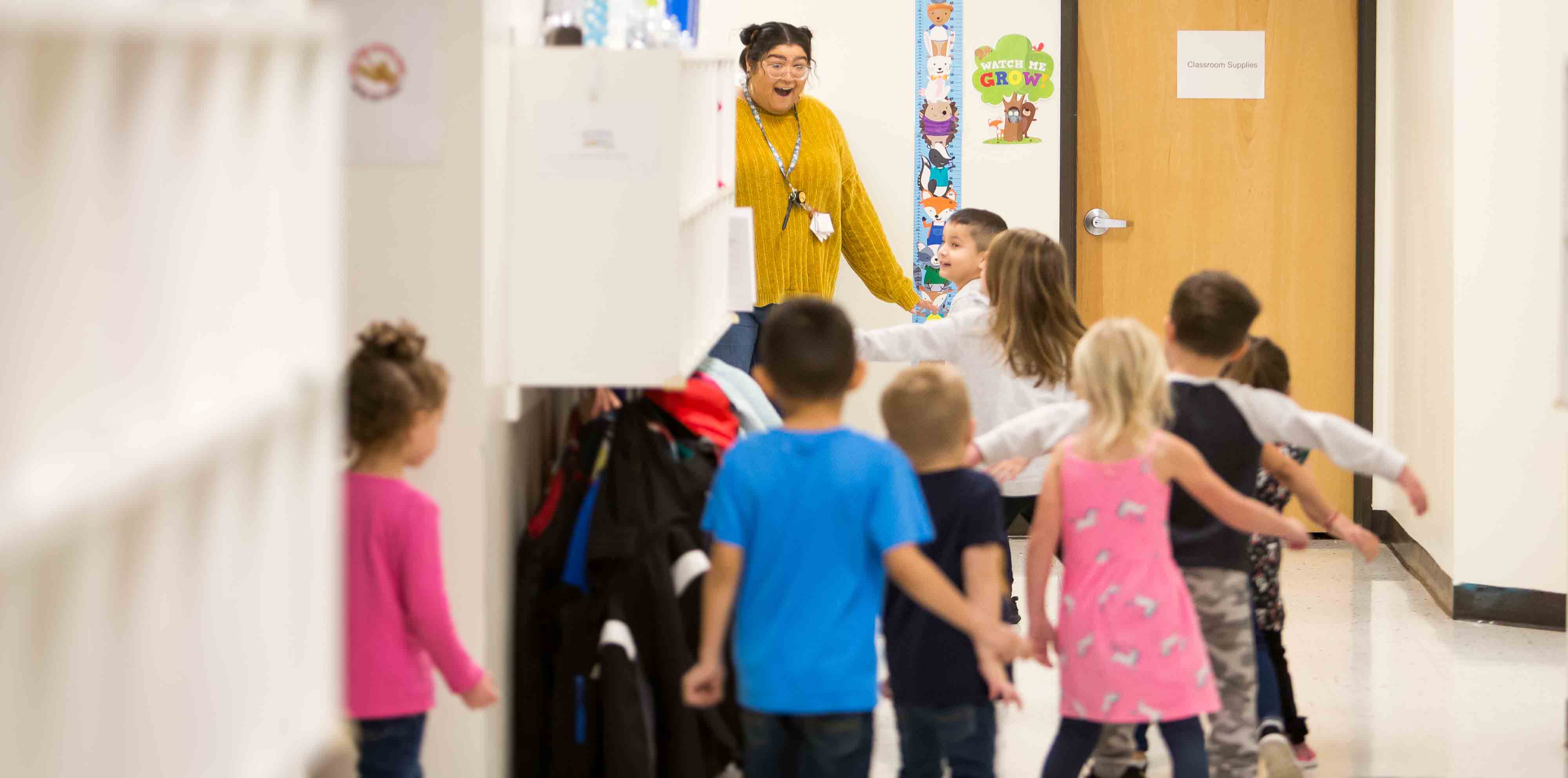 Student in walking in line out of a classroom.