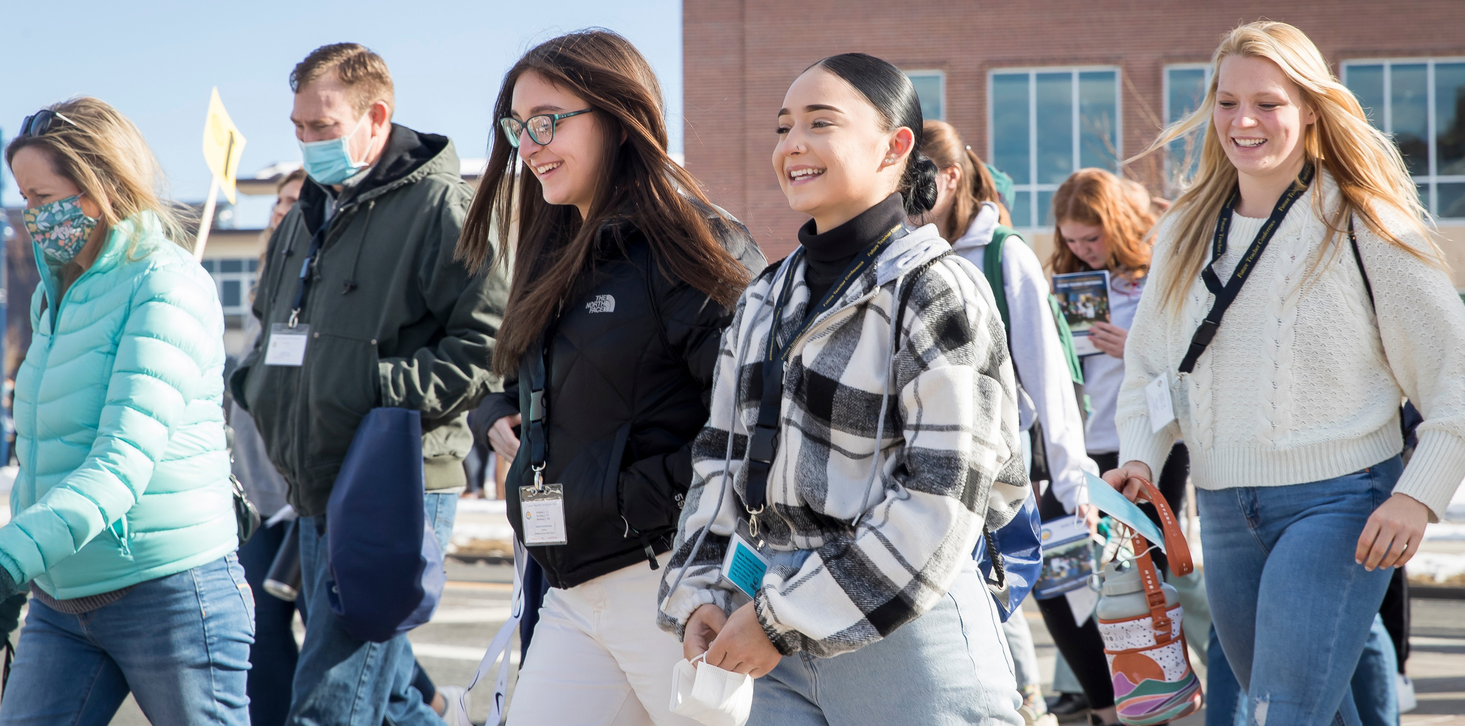 Four future students smiling and walking outside