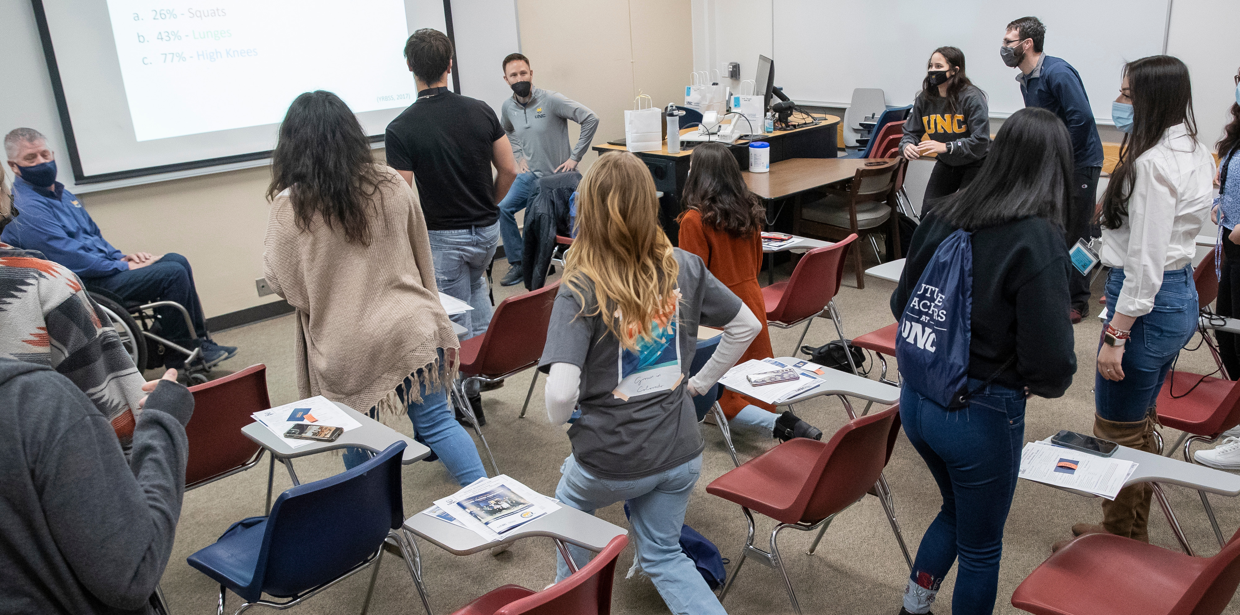 Students lunging in a classroom