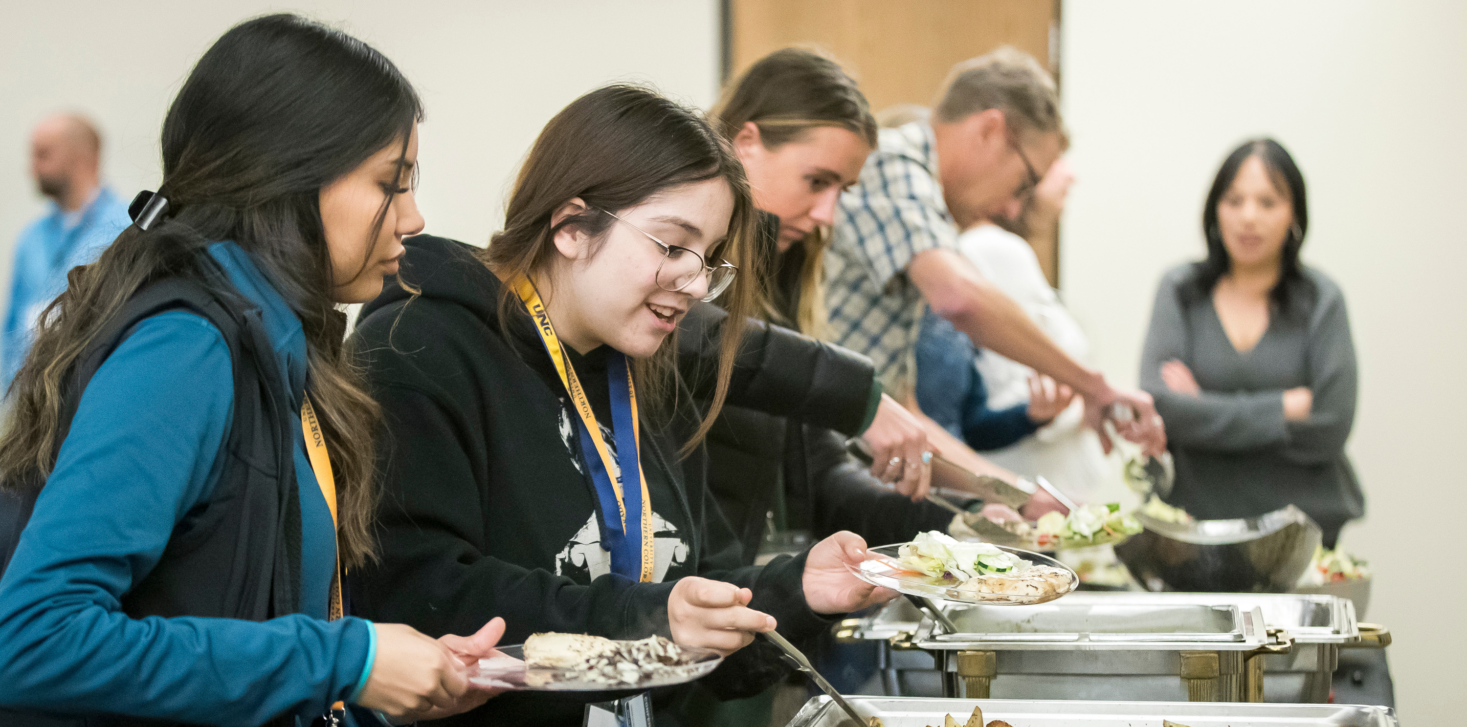 Students grabbing food at a buffet