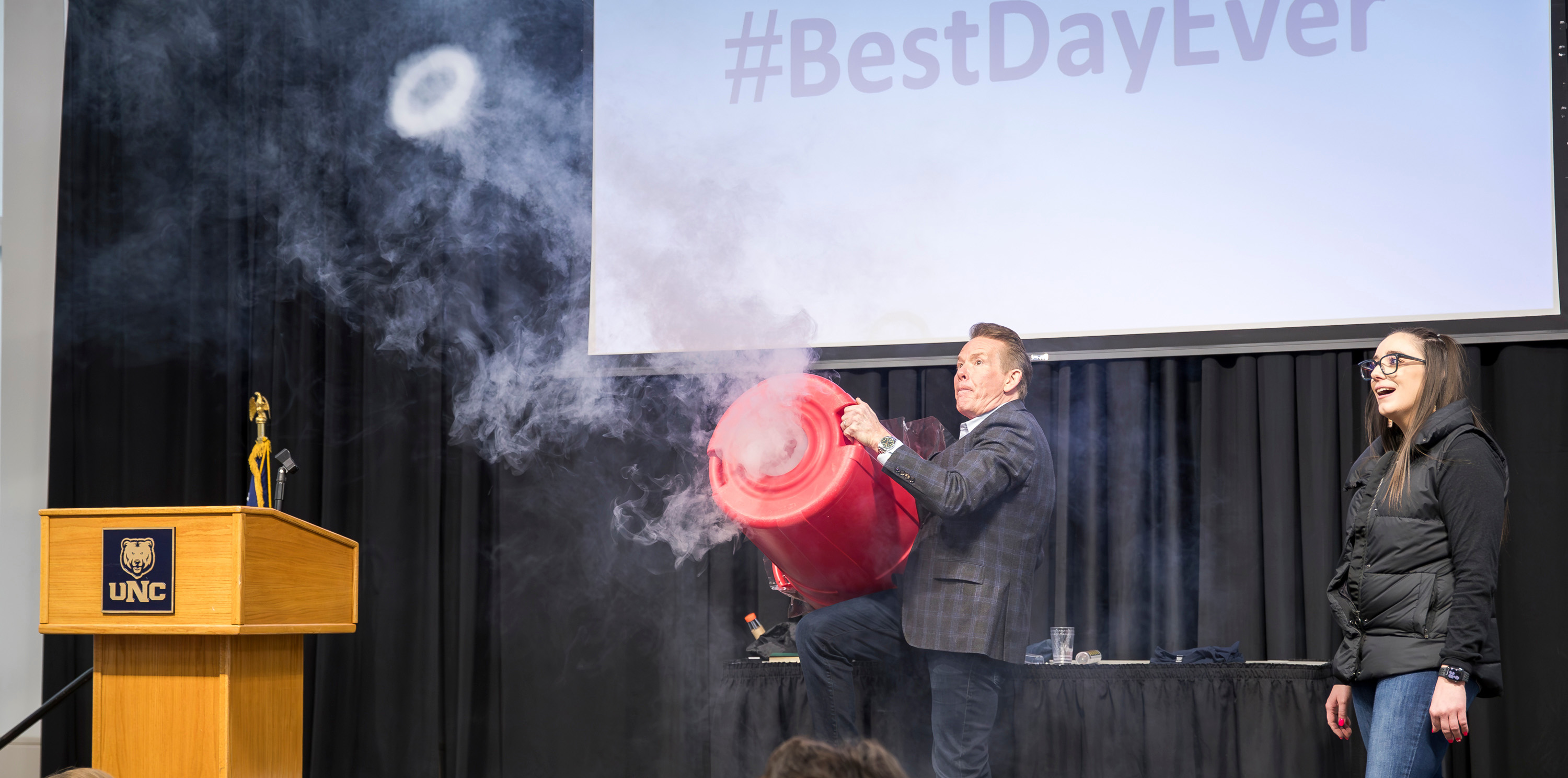 A man holding a trash can that made steam