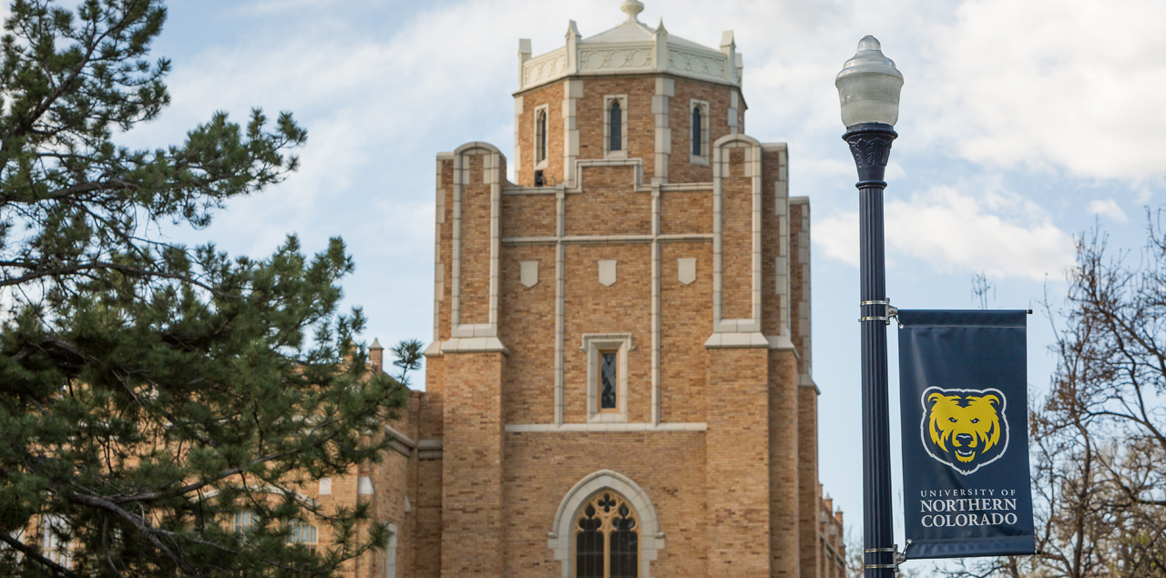 Top of Gunter Hall with a UNC flagpole in the foreground.