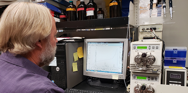 Steve Mackessy using one of his tools in his lab.