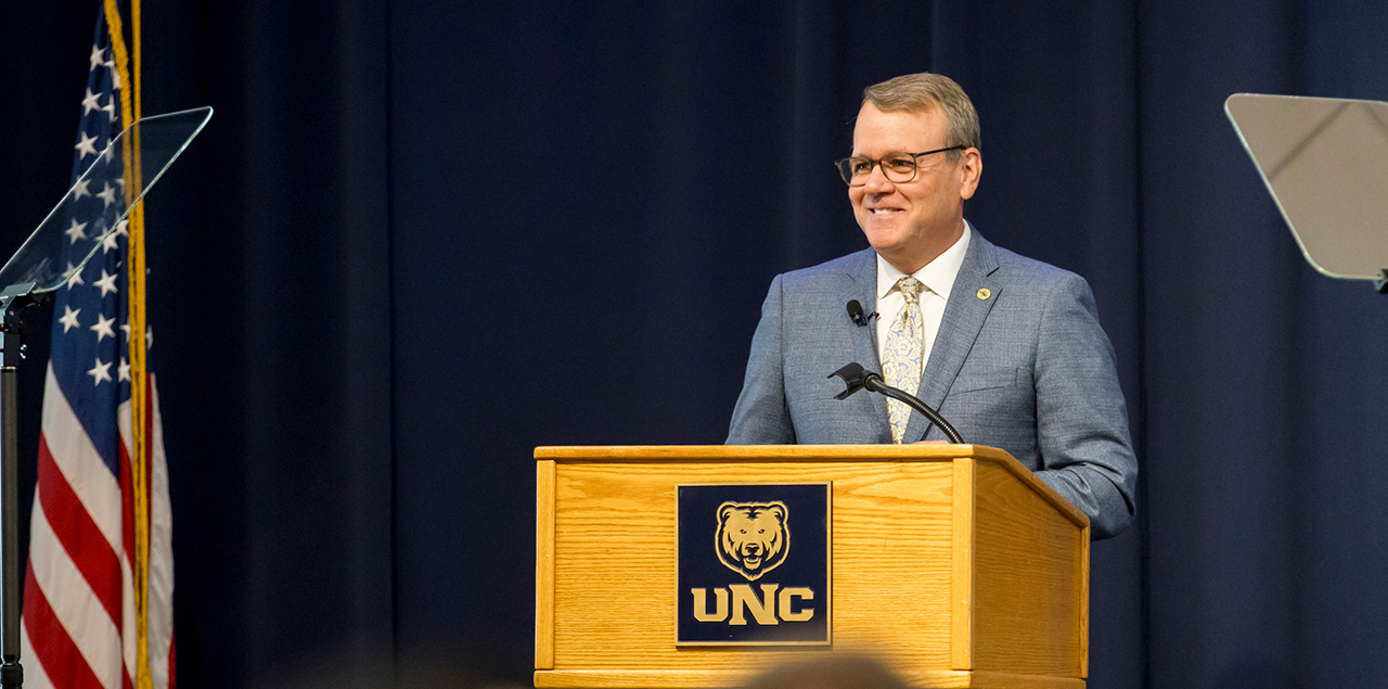 President Andy Feinstein standing at a podium speaking