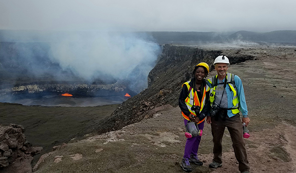 Steven Anderson poses with his graduate student Davitia James over the Kilauea lava lake in Hawaii.