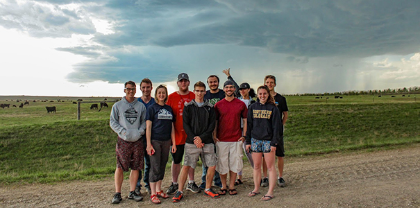 UNC students in front of a storm they chased in May 2019.