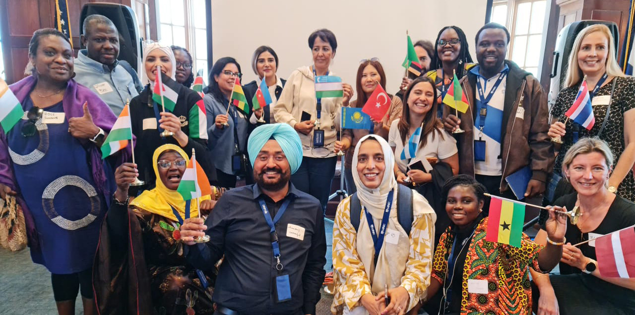 A group of international teachers holding up their native flags