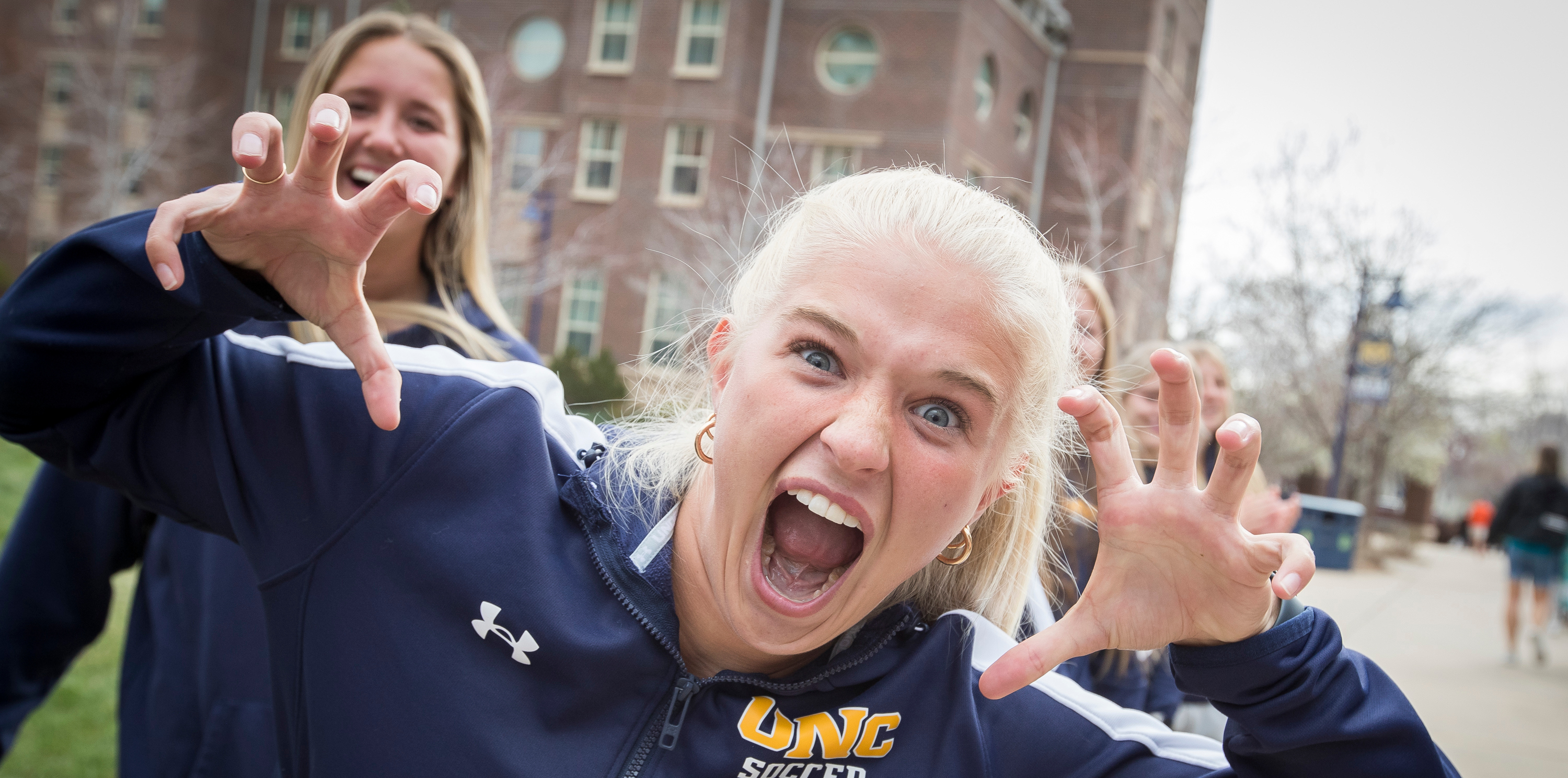 A volleyball player putting up bear claws in front of the camera