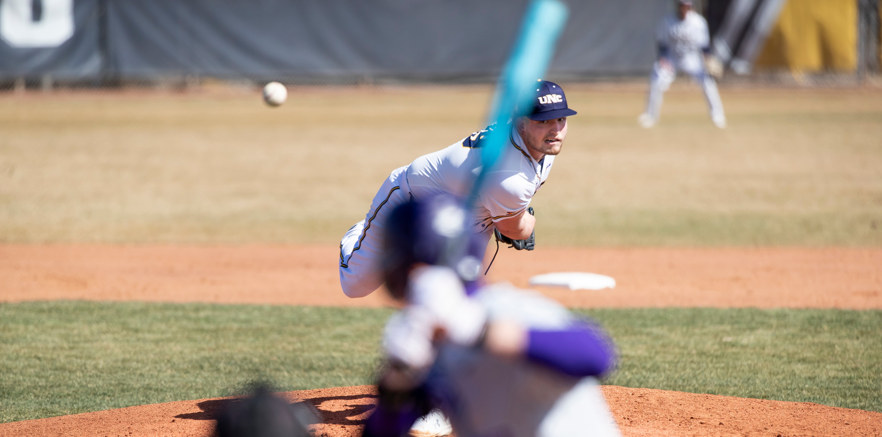 A UNC pitcher throwing a baseball