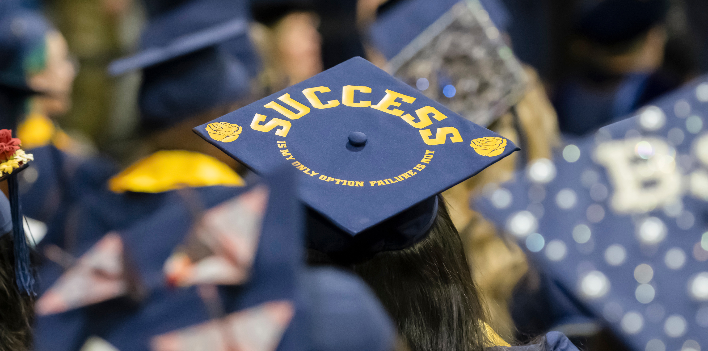A graduation cap that has the word success written on it