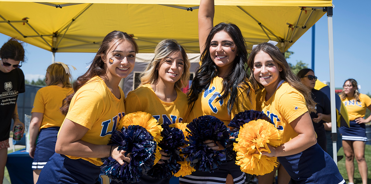 Four cheerleaders posing for a picture