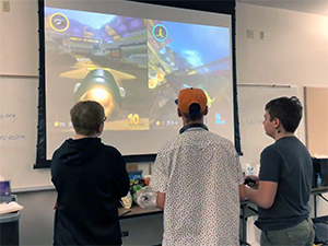 One of the design teams playtests MarioKart 8 in order to analyzes the game dynamics to build ideas for their team’s game design. 