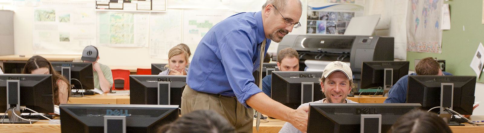 Geography professor and student working at computer