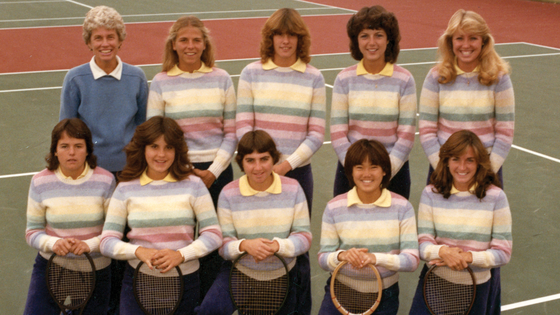 1984 UNC Tennis Team pose together with their tennis raquets.