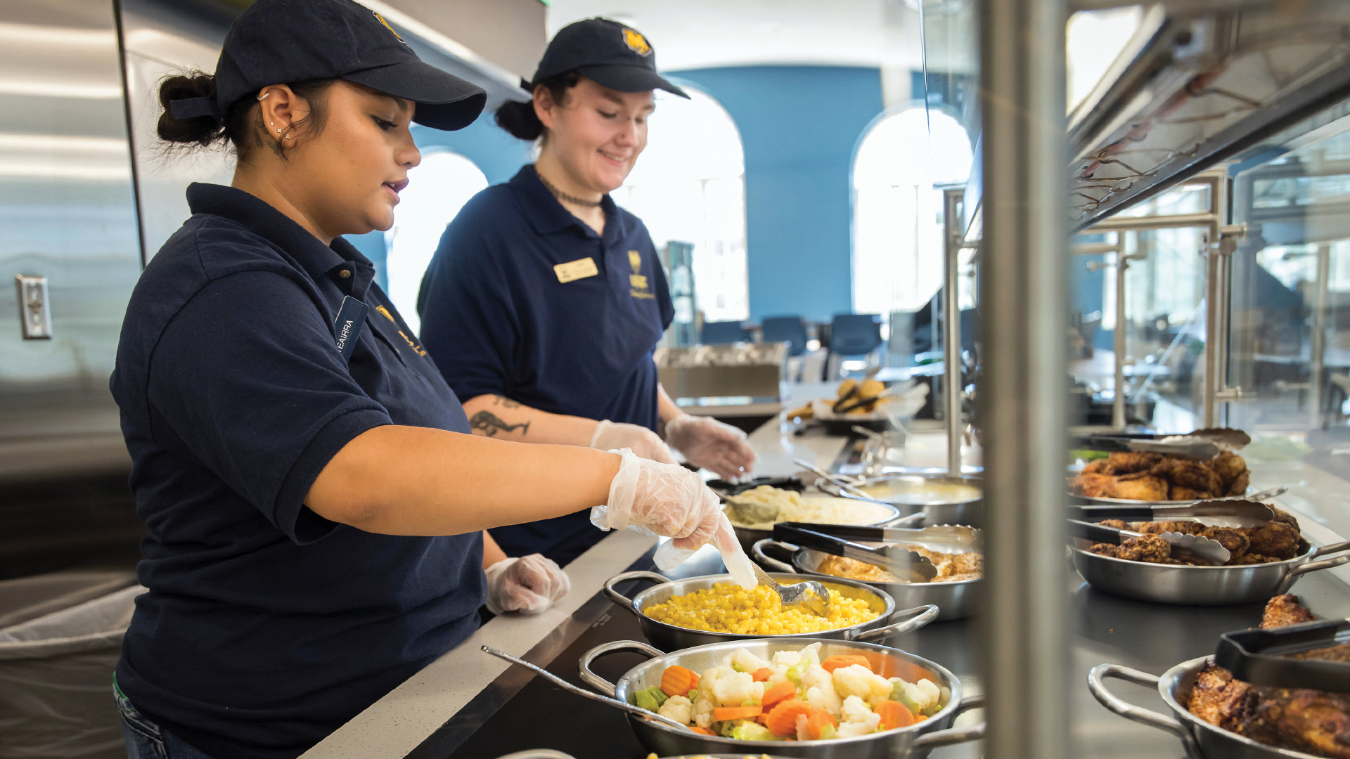 Dining Hall workers serving food.