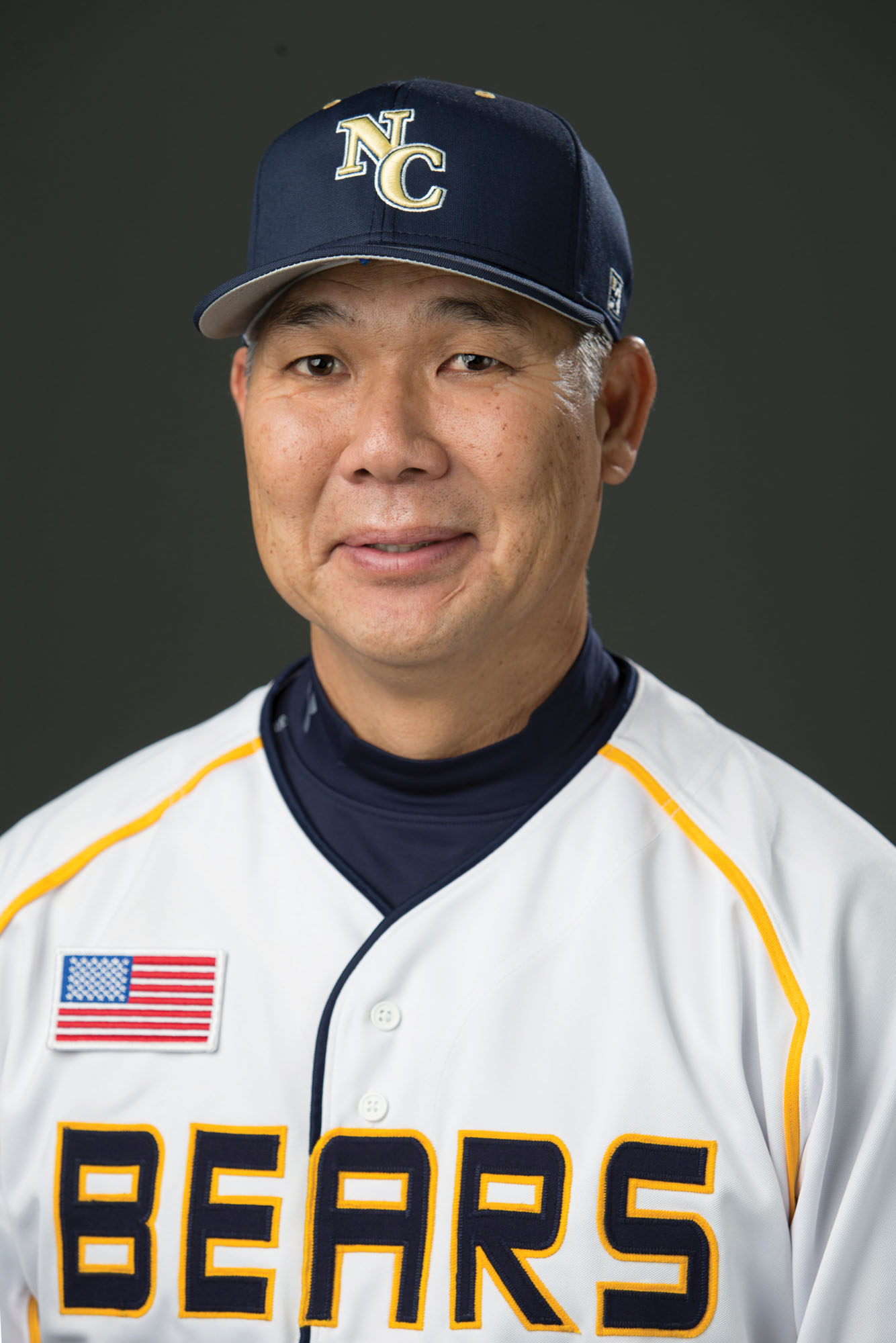 Headshot of Coach Carl Iwasaki.