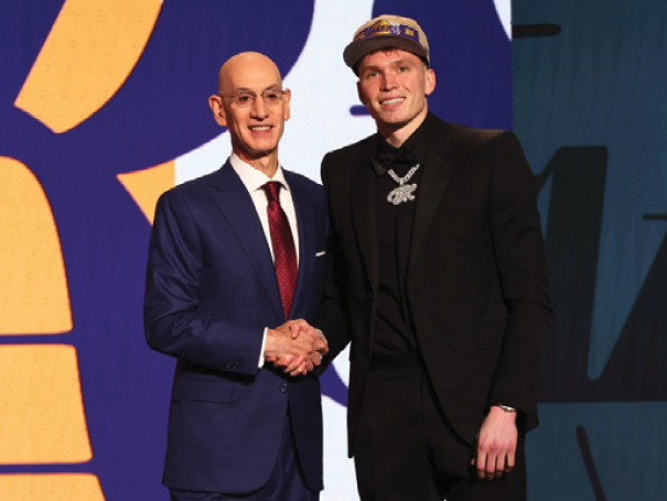 Dalton Knecht, UNC class of '23, shakes hands with NBA commissioner Adam Silver after being drafted by the L.A. Lakers