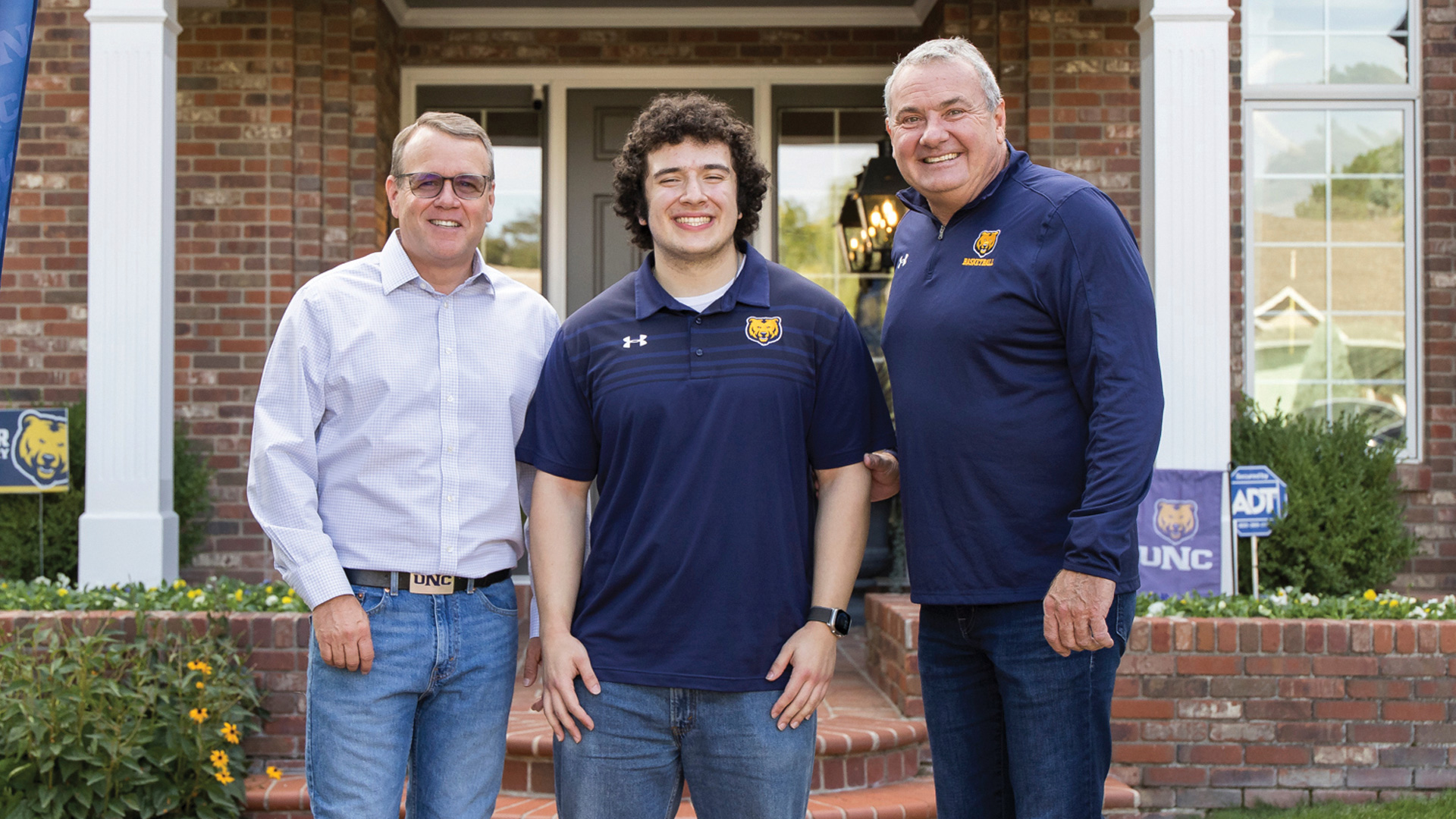 UNC President Andy Feinstein, business and mathematics major Daniel Garza and alumnus John Schmidt, ’84